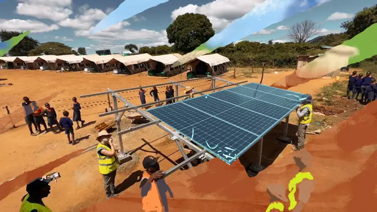 Low aerial shot of people setting up a solar panel system in a remote village