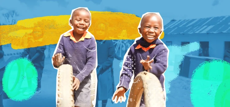 Two kids smile while rolling tires for fun