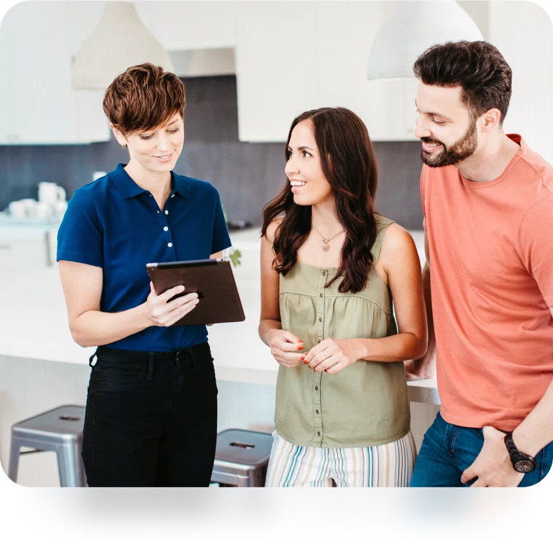 salesrep with homeowners pointing at a tablet